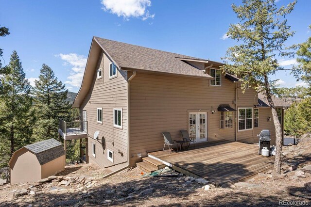 6530 Ridgeview Dr, Morrison, CO 80465 - back of property featuring a wooden deck, a shed, an outbuilding, french doors, and roof with shingles