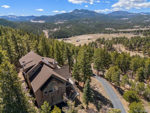 6530 Ridgeview Dr, Morrison, CO 80465 - aerial view of property and surrounding area with a mountain backdrop and a heavily wooded area
