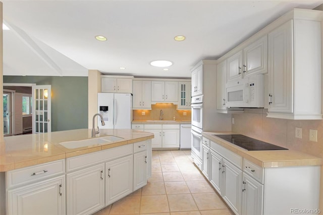 6684 E Bates Ave, Denver, CO 80224 - kitchen featuring white appliances, a sink, tasteful backsplash, light countertops, and recessed lighting
