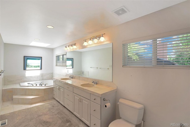 6684 E Bates Ave, Denver, CO 80224 - bathroom featuring a garden tub, double vanity, toilet, tile patterned flooring, and recessed lighting