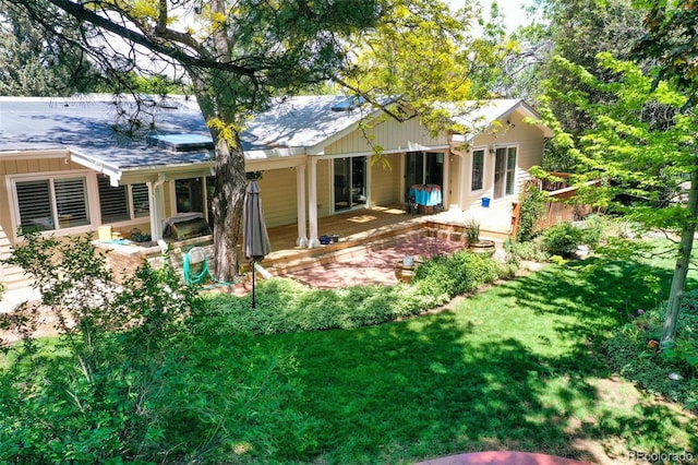 6684 E Bates Ave, Denver, CO 80224 - back of property with a yard, a shingled roof, and a deck