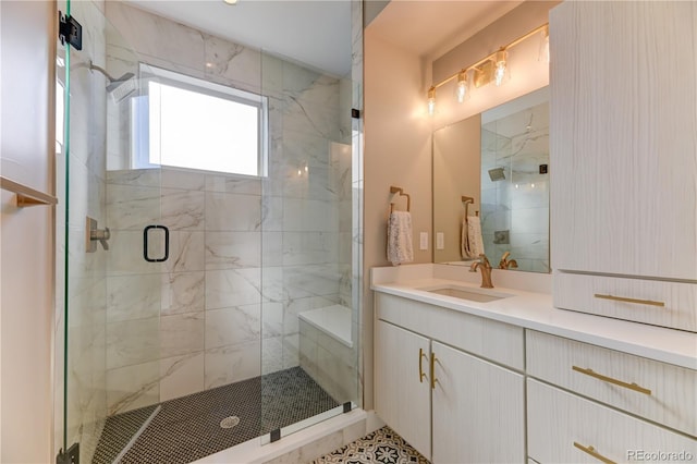 bathroom featuring walk in shower and vanity