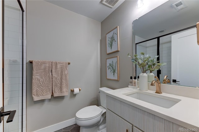 bathroom featuring tile patterned floors, vanity, and toilet