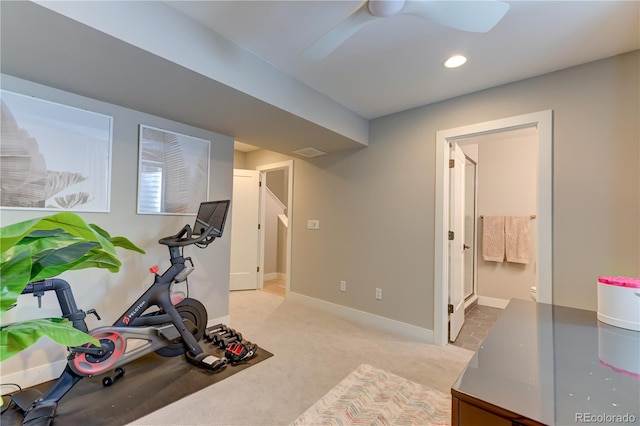 workout area with ceiling fan and light colored carpet