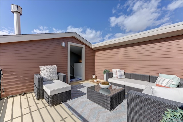 wooden deck with an outdoor living space and a patio