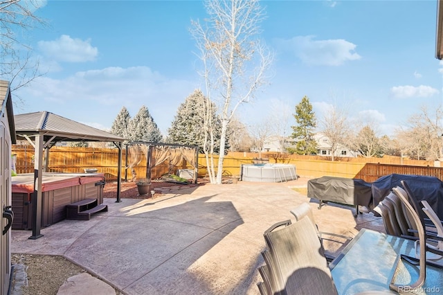 view of patio / terrace featuring a swimming pool with hot tub