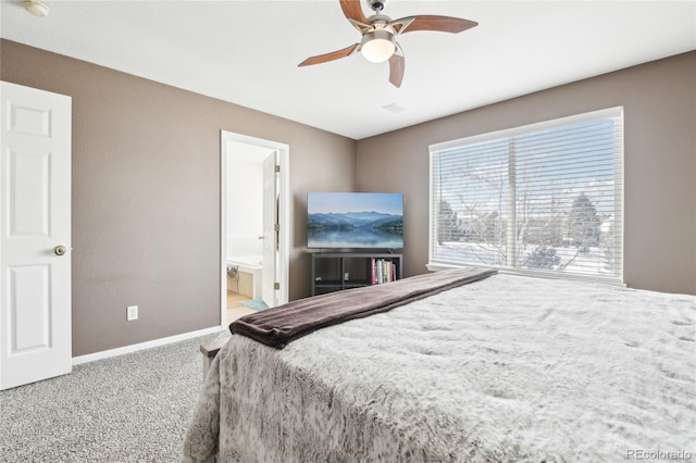 bedroom with ceiling fan, carpet, and ensuite bath