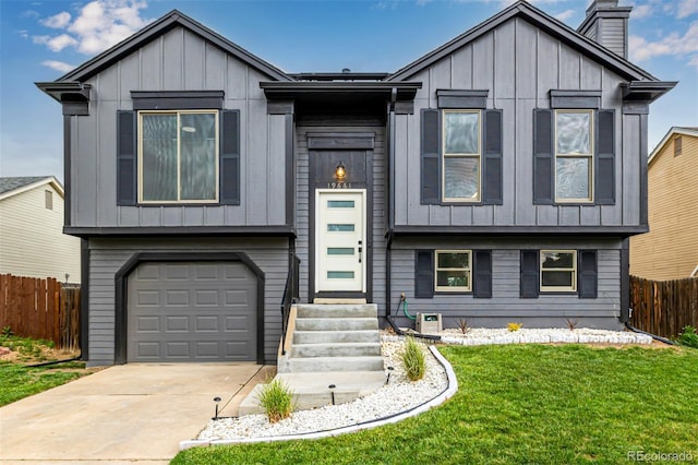 19661 E Girard Ave, Aurora, CO 80013 - view of front of home featuring board and batten siding, an attached garage, entry steps, concrete driveway, and a chimney