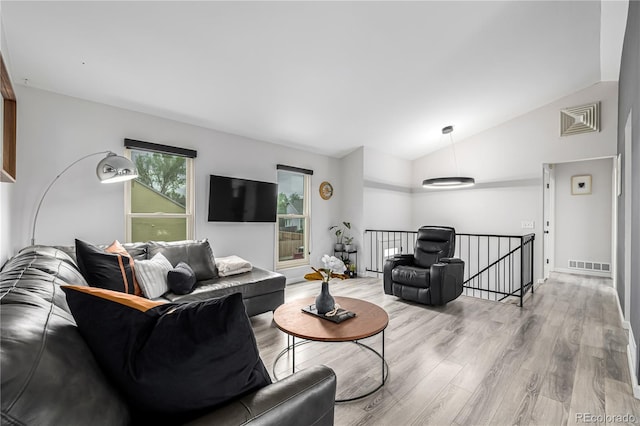 19661 E Girard Ave, Aurora, CO 80013 - living area featuring vaulted ceiling and light wood-style flooring