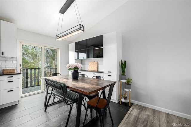 19661 E Girard Ave, Aurora, CO 80013 - dining space with vaulted ceiling, baseboards, and dark wood finished floors