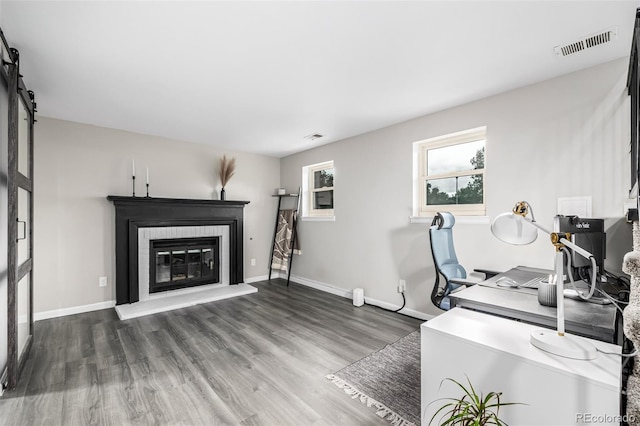 19661 E Girard Ave, Aurora, CO 80013 - office area featuring wood finished floors, a glass covered fireplace, and baseboards