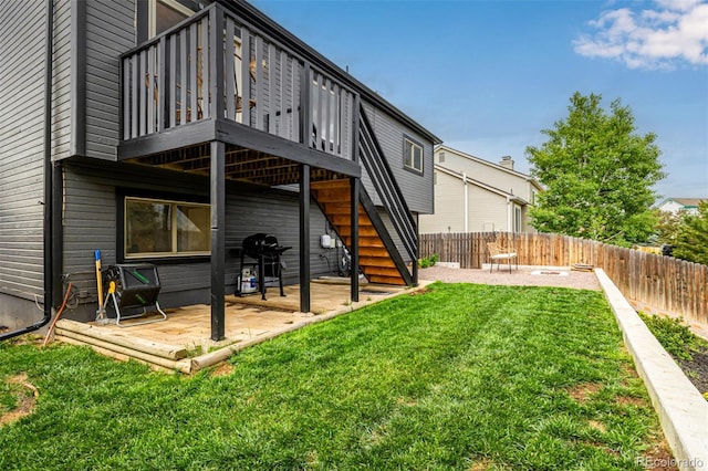 19661 E Girard Ave, Aurora, CO 80013 - back of property with a patio, stairway, and a wooden deck