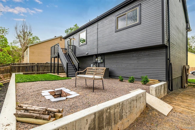 19661 E Girard Ave, Aurora, CO 80013 - rear view of property with stairs, an outdoor fire pit, fence, and a wooden deck