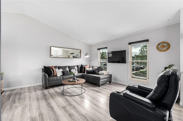 19661 E Girard Ave, Aurora, CO 80013 - living room featuring vaulted ceiling, light wood finished floors, and baseboards
