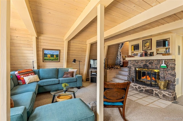 771 Spruce Rd, Cimarron, CO 81220 - carpeted living room with a wood ceiling with exposed beams, wooden walls, stairway, and a fireplace