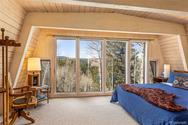771 Spruce Rd, Cimarron, CO 81220 - carpeted bedroom featuring wood walls, vaulted ceiling, multiple windows, and wood ceiling