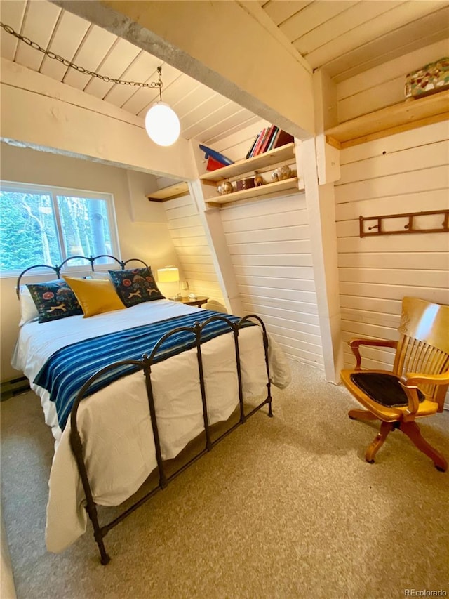 771 Spruce Rd, Cimarron, CO 81220 - carpeted bedroom with wooden walls and a wooden ceiling with exposed beams