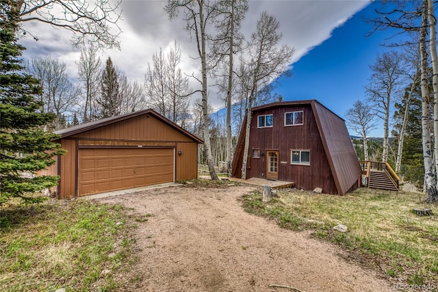 771 Spruce Rd, Cimarron, CO 81220 - view of front of home with an outdoor structure, a gambrel roof, driveway, stairs, and a detached garage
