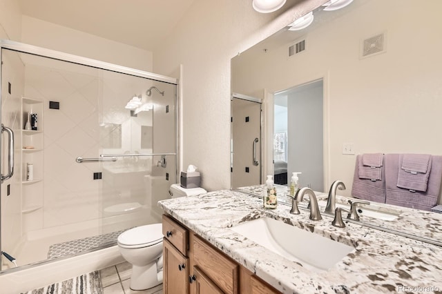 bathroom featuring visible vents, a stall shower, toilet, and vanity