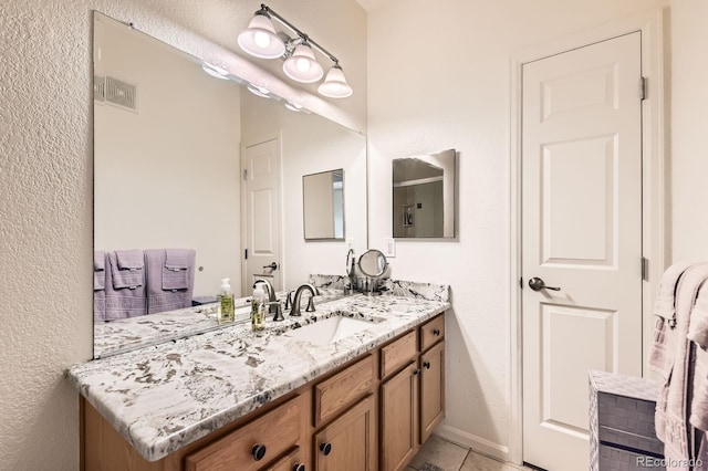 bathroom featuring visible vents, vanity, and tile patterned flooring