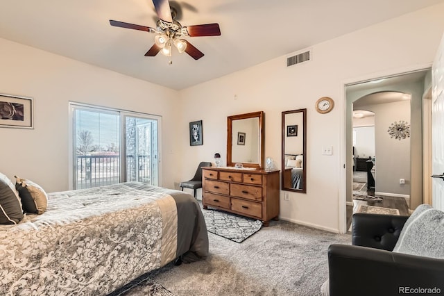 bedroom with visible vents, baseboards, carpet floors, arched walkways, and access to outside