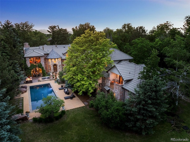 exterior space with a patio area and exterior fireplace