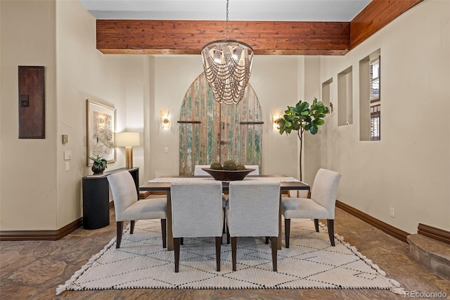 dining area featuring beamed ceiling and an inviting chandelier