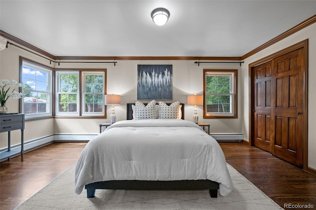 bedroom featuring a baseboard heating unit, dark hardwood / wood-style floors, and crown molding