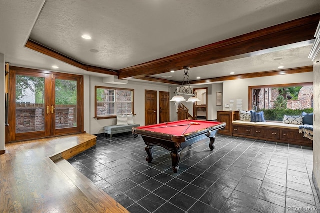 playroom with a textured ceiling, billiards, ornamental molding, and french doors