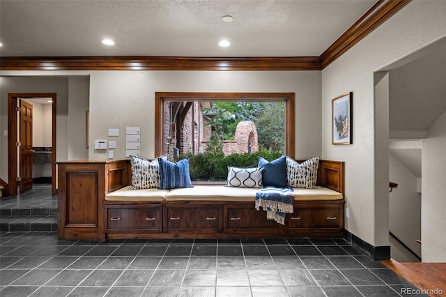 sitting room with baseboards, a textured ceiling, recessed lighting, and crown molding