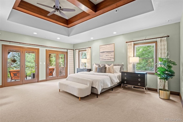 carpeted bedroom featuring baseboards, access to outside, a tray ceiling, french doors, and recessed lighting