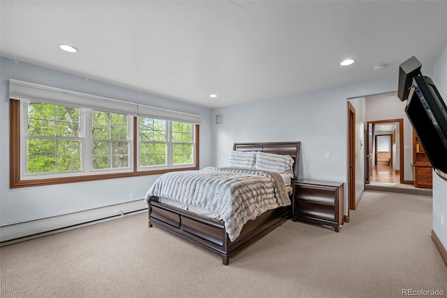 bedroom with light carpet, baseboard heating, and recessed lighting