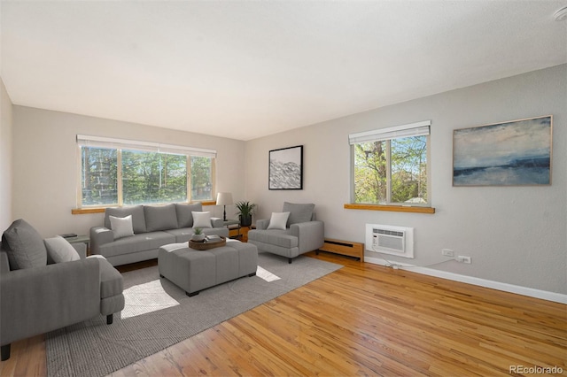 1144 N Ogden St Unit 304, Denver, CO 80218 - living room featuring wood finished floors, plenty of natural light, an AC wall unit, and baseboard heating