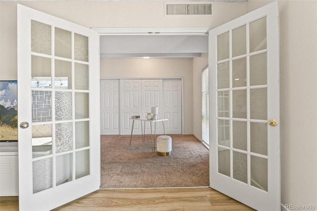 entryway featuring carpet and french doors