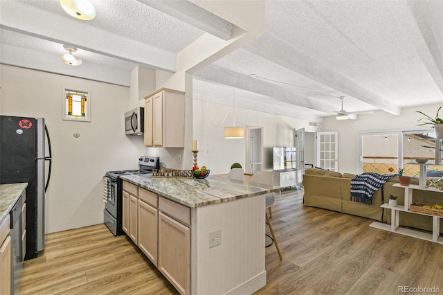 kitchen featuring appliances with stainless steel finishes, light hardwood / wood-style flooring, light brown cabinetry, and beam ceiling