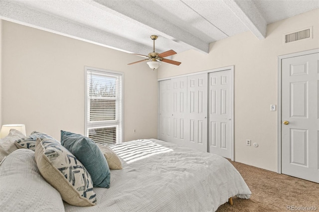 bedroom with carpet flooring, beam ceiling, and ceiling fan