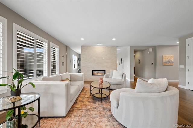 5608 Raintree Dr, Parker, CO 80134 - living room featuring recessed lighting, a fireplace, wood finished floors, and baseboards
