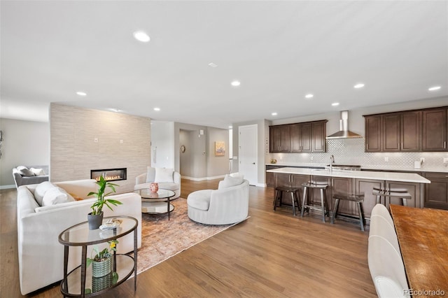 5608 Raintree Dr, Parker, CO 80134 - living area with wood finished floors, baseboards, recessed lighting, and a tiled fireplace