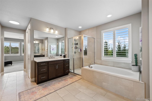 5608 Raintree Dr, Parker, CO 80134 - bathroom with vanity, a garden tub, a shower stall, tile patterned floors, and recessed lighting
