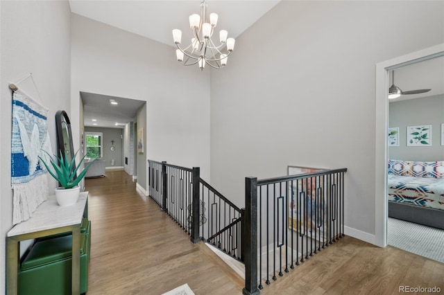 5608 Raintree Dr, Parker, CO 80134 - hall featuring wood finished floors, an upstairs landing, a chandelier, and a high ceiling