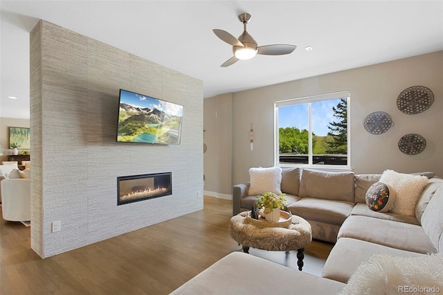 5608 Raintree Dr, Parker, CO 80134 - living area with wood finished floors, ceiling fan, and a large fireplace