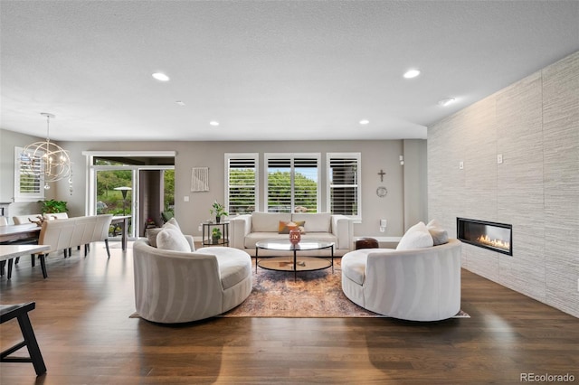5608 Raintree Dr, Parker, CO 80134 - living area with dark wood-type flooring, plenty of natural light, recessed lighting, a tile fireplace, and a chandelier