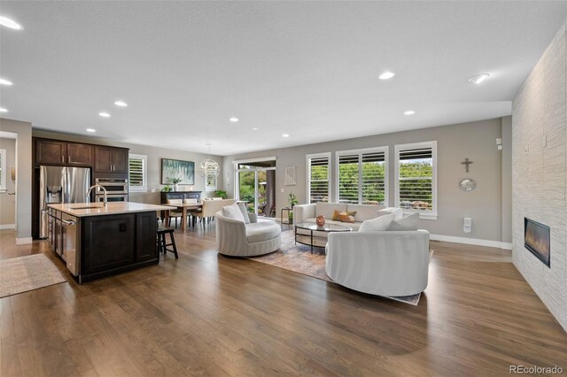 5608 Raintree Dr, Parker, CO 80134 - living area with dark wood finished floors, recessed lighting, and a large fireplace