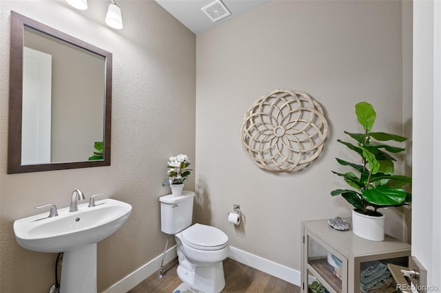 5608 Raintree Dr, Parker, CO 80134 - half bathroom with wood finished floors and toilet