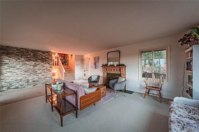 living room featuring carpet, stairway, and a fireplace