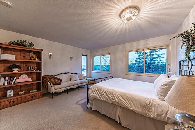 bedroom with carpet flooring and a textured ceiling