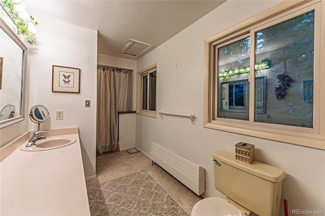 full bathroom featuring radiator, vanity, and toilet