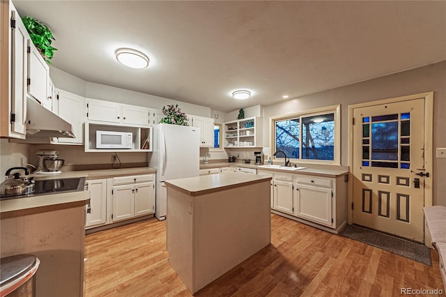 kitchen featuring open shelves, a sink, light wood-type flooring, white appliances, and under cabinet range hood