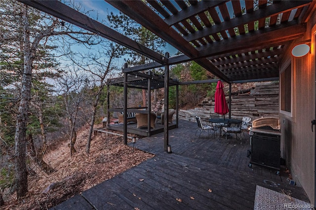 deck featuring outdoor dining area, area for grilling, and a pergola