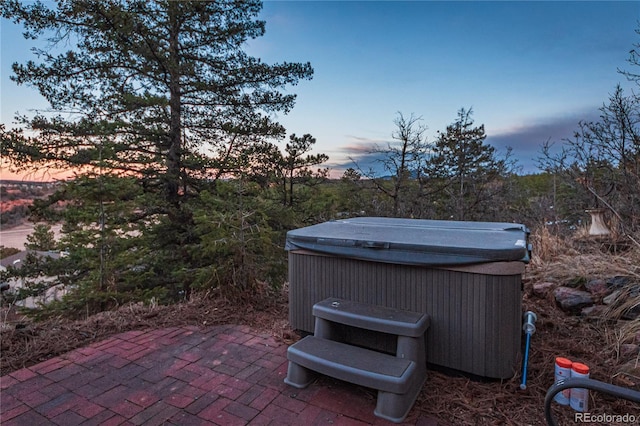 patio terrace at dusk with a hot tub